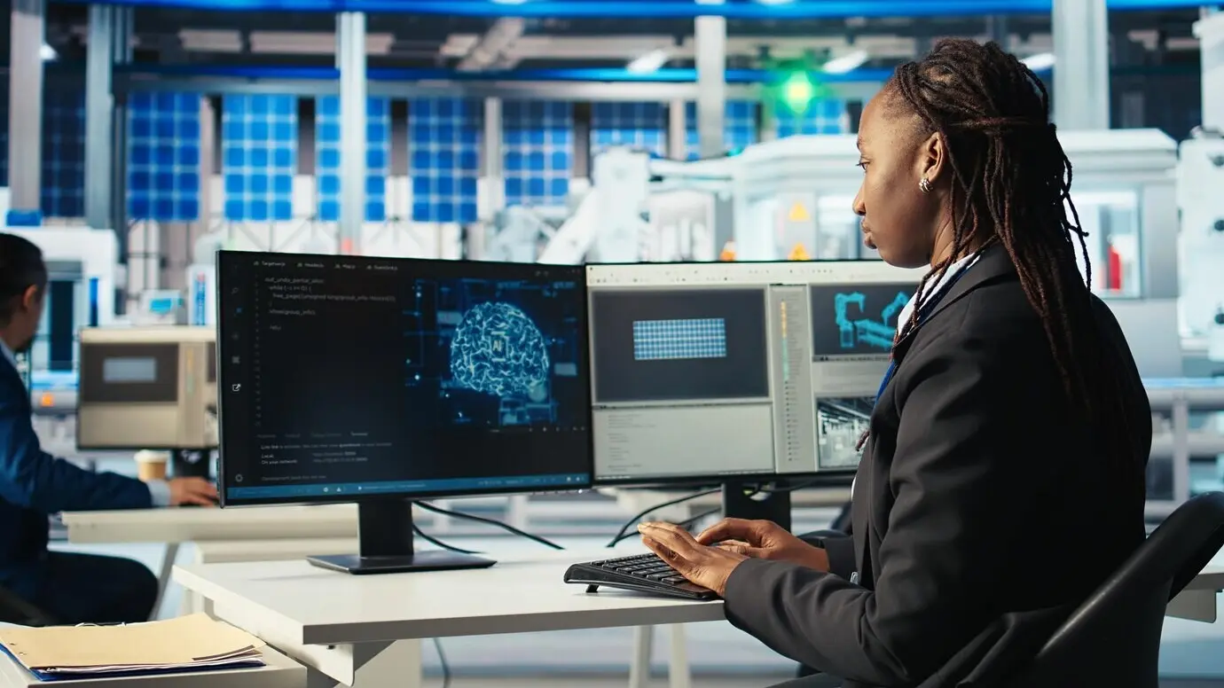 Programmer at a photovoltaics factory employing AI to monitor system performance