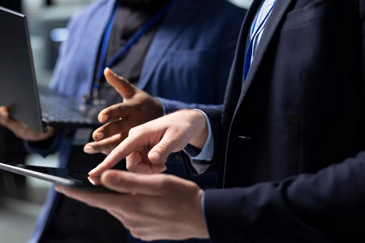 A multiethnic team of technicians and building contractors examining data.